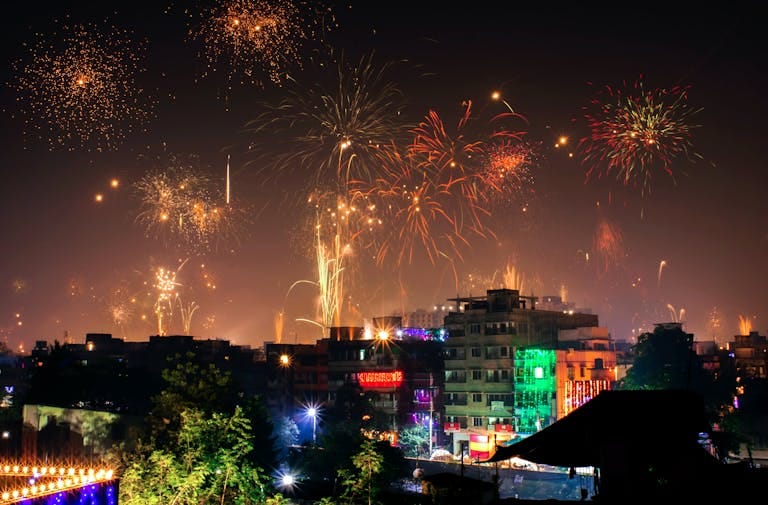 Vibrant fireworks light up the night sky during a diwali festival in an Indian city.